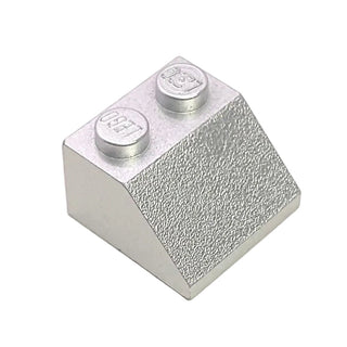 White plastic slope brick with 45-degree angle, two stud connections on top, textured front face.