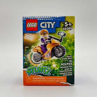 LEGO City set 60309 box featuring orange stunt bike with minifigure and selfie stick accessory.