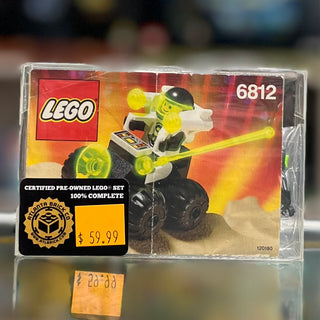 LEGO Space set 6812 in clear plastic case with yellow and black wheeled vehicle on orange and yellow background packaging.