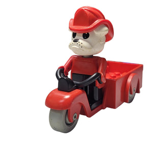 LEGO Fabuland bulldog character with white face and black nose wearing red hat and shirt, seated on red tricycle with cargo a