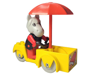White horse figure in red and black outfit riding yellow ice cream cart with red umbrella canopy.