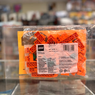 LEGO polybag containing orange bricks and pieces in clear plastic packaging with yellow label and product information.