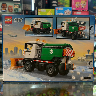 LEGO City snowplow truck set 60490 with white cab, green bed, orange plow blade, and minifigure.