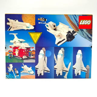 White and blue LEGO space shuttle with black engines shown from multiple angles on product box packaging.
