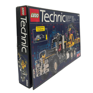 LEGO Technic set 8868 box featuring pneumatic compressor system and yellow industrial vehicle with mechanical claw attachment
