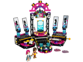 LEGO Friends pop star stage set with pink and black construction featuring screens, speakers, keyboard, and two minifigures.