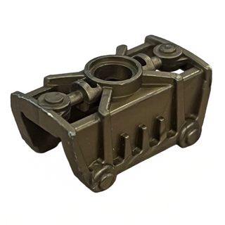 Dark gray plastic Bionicle knee cover armor piece with circular opening and articulated joint connectors.