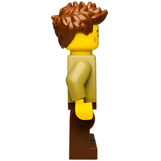 LEGO Ninjago minifigure with brown spiky hair, yellow face and hands, tan torso with arm detail, and brown legs.