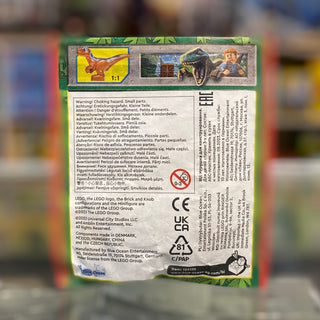 Back of LEGO Jurassic World set box with warning labels, product information, and dinosaur imagery.