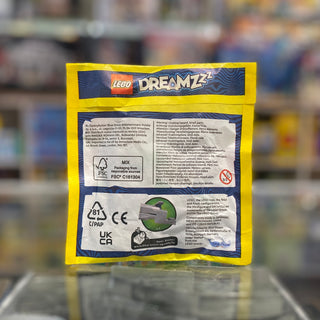 Yellow paper bag with blue LEGO DREAMZzz branding and product information panels on reverse side.
