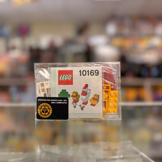 LEGO set 10169 in clear polybag with instruction manual and certified pre-owned seal visible.