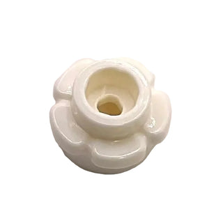 White plastic flower-shaped edging piece with central cylindrical post and four curved petal sections.