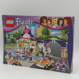 LEGO Friends Heartlake Frozen Yogurt Shop set 41320 with minifigures, building pieces, and two yellow vehicles.
