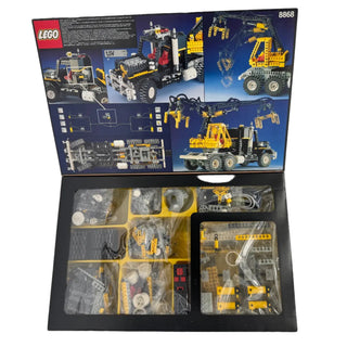 LEGO Technic Air Tech Claw Rig 8868 set open box showing instruction manual and organized parts in compartments.