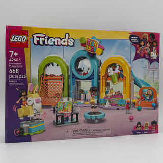 LEGO Friends set 42686 with colorful arched structures, minifigures, trampoline, stage, and play equipment on display box.