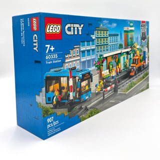 LEGO City Train Station set 60335 box showing blue train, station building, and street scene with 907 pieces.