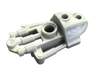 White plastic Bionicle armor piece with cylindrical connectors and circular ports for leg assembly.