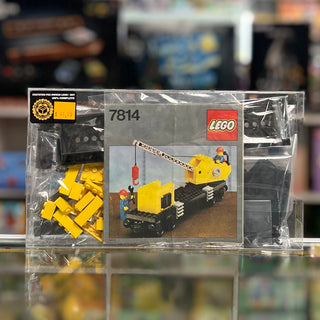 LEGO Train set 7814 box containing yellow crane wagon with small red container and minifigures.