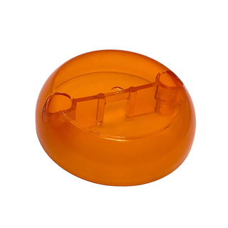 Orange translucent hemisphere pod half with two pin holes visible on the flat interior surface.