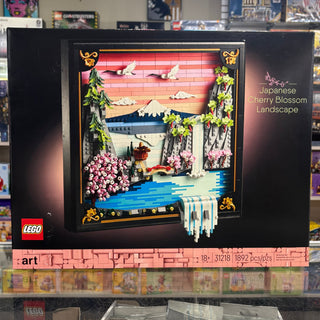 LEGO Art set 31218 featuring a framed Japanese cherry blossom landscape with pink flowers, blue water, and snow-capped mounta