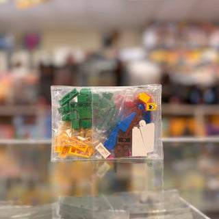 Polybag containing green, yellow, red, blue, and white LEGO bricks and a minifigure with bunny ears.