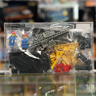 LEGO Train crane wagon set containing yellow and black crane structure, red container, two blue minifigures, and assorted bla