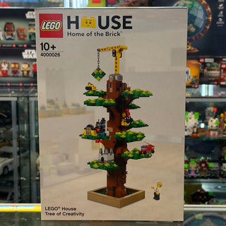 LEGO House Tree of Creativity set box showing brown tree trunk with green platforms, yellow crane, hanging gem, and minifigur