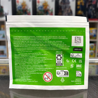 White paper bag with green panel displaying LEGO branding, safety warnings, and multilingual product information.