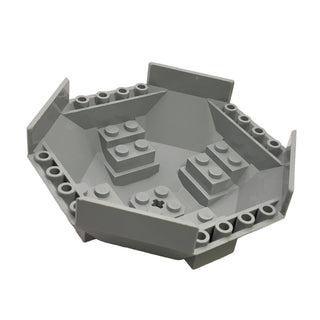 Gray octagonal cockpit component with raised walls, internal studs, and center axle hole.