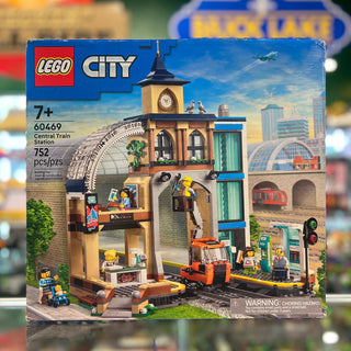 LEGO City Central Train Station set 60469 with clock tower, train track, minifigures, and orange train car.