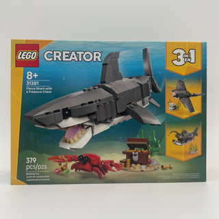 LEGO Creator set box showing gray shark with open mouth, red crab, and brown treasure chest with seaweed and coral details.