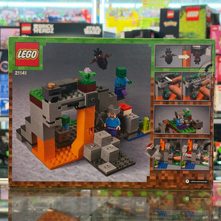 LEGO Minecraft set 21141 featuring a blocky cave structure with orange supports, minifigures, and a black bat piece.