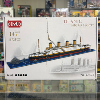 Titanic Micro Blocks construction set containing 1872 pieces with assembled ship model displayed on blue base.