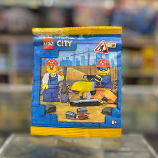 LEGO City construction set package with two minifigures wearing hard hats, yellow machinery, and tools on blue and yellow bag