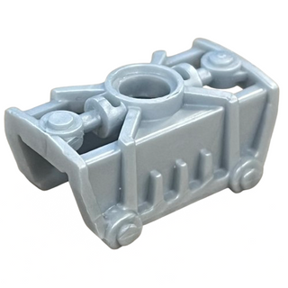 Light gray Bionicle armor piece with cylindrical center opening and mechanical side extensions.