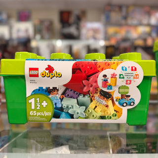 LEGO Duplo Brick Box 10913 with green storage container, colorful bricks, minifigure, and toy car.