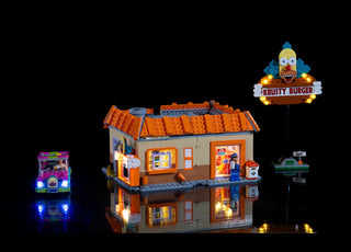 LEGO Krusty Burger set with illuminated windows, sign, and Krusty character figure, displayed with separate lit arcade machin