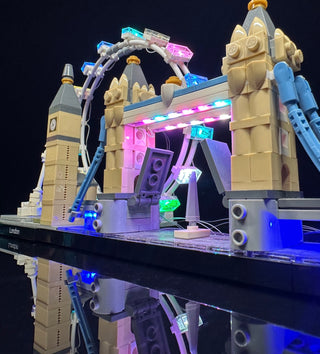 LEGO London Skyline set with custom lighting kit installed, featuring Big Ben, Tower Bridge, and colored LED lights in blue, 