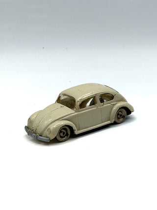 Light gray LEGO VW Beetle scale model with rounded body, side windows, and black wheels on white background.