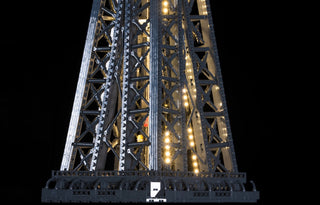 LEGO Eiffel Tower model illuminated with warm white and cool white LED lights throughout the structure.