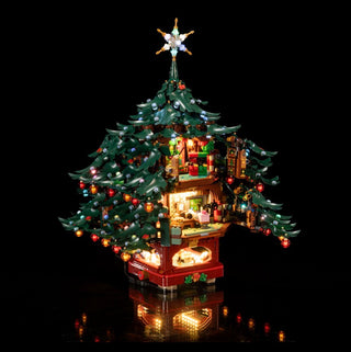 LEGO Christmas tree structure with illuminated interior rooms, decorated branches, gold star topper, and warm LED lighting th