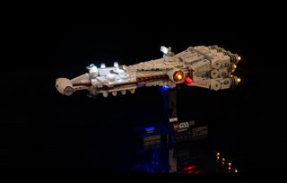 LEGO Tantive IV spaceship with white, blue, orange, and red LED lights installed, displayed on dark stand against black backg