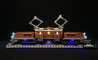 Brown and red LEGO locomotive with white, blue, and warm yellow LED lights installed throughout the set on black display base