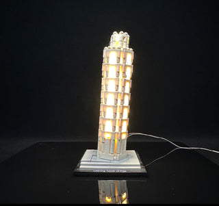 LEGO Leaning Tower of Pisa set illuminated with warm white LED lights throughout the structure and base, with power cord visi