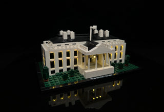 White House LEGO set with interior and exterior yellow LED lights illuminated throughout the building structure.