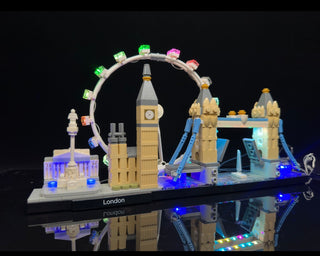LEGO London skyline set illuminated with multicolored LED lights on buildings and circular structure against dark background.