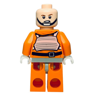 LEGO minifigure with tan head, orange pilot suit with gray chest panel, white hands, and orange legs with red circles.