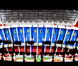 Illuminated LEGO Camp Nou stadium facade with blue, red, and green LED lighting segments spelling "FCB BARCELONA."