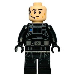 Minifigure with tan head wearing headset, black torso with detailed technical panel printing, and black legs with mechanical 