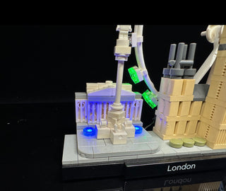 LEGO London skyline set illuminated with blue, purple, and green LED lights on architectural structures.